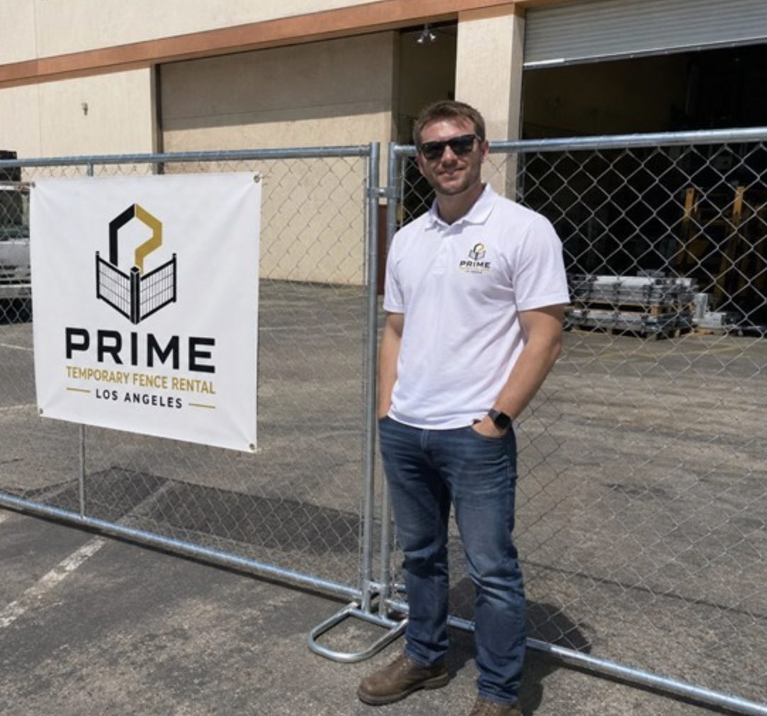 Temporary construction fence panels around a warehouse job site