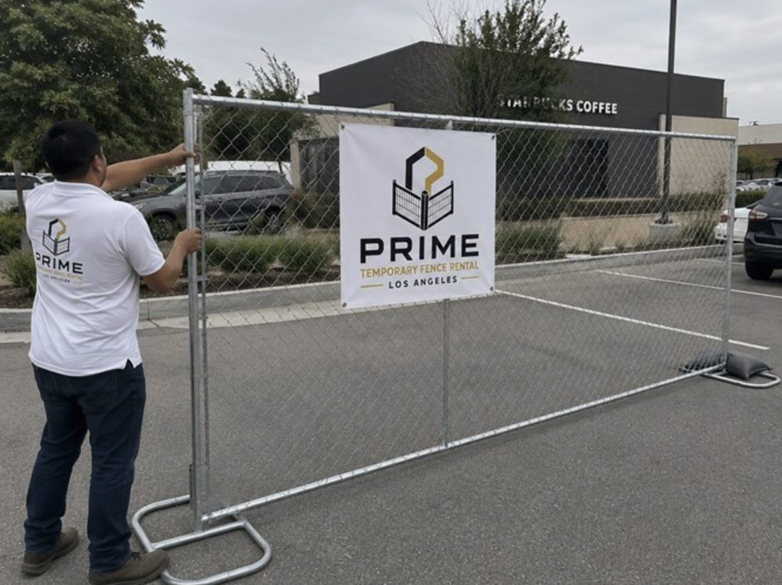 Crew installing temporary fence panels at a commercial property